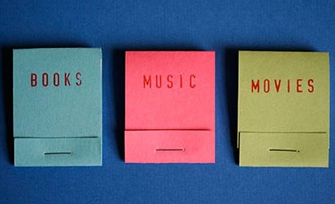 three matchbooks printed with the words books, movies, music